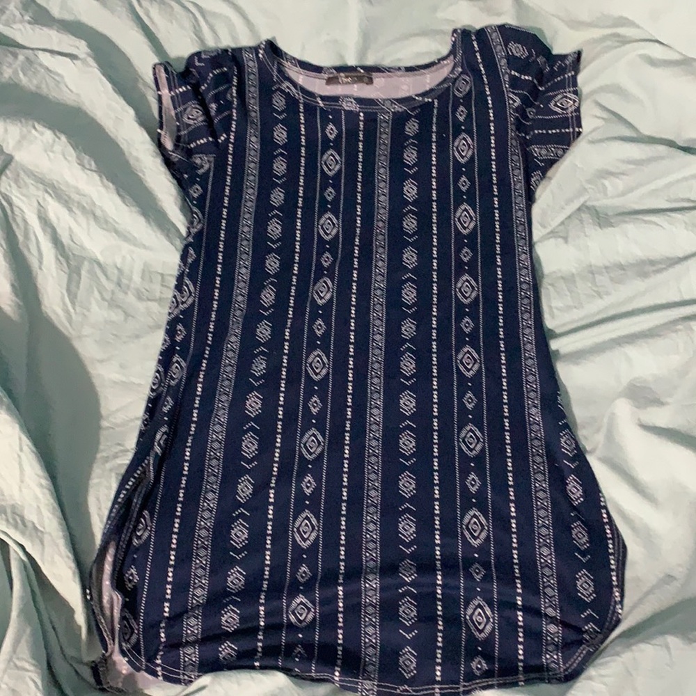 Dark navy shirt with white patterns/designs.